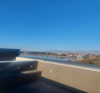 View from a holiday apartment in Privlaka on Privlaka Street by the river and mountains.