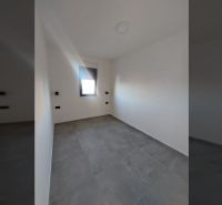 Room with tiles and a window in a recreational apartment.