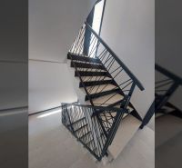 Staircase with metal railing and floor with wooden decor in a Holiday Apartment.