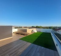 A terrace with a wooden decor floor in a holiday apartment in Privlaka, Privlaka.