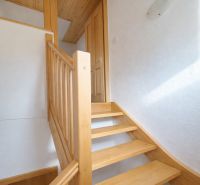Interior of a family house with a wooden staircase and flooring with a wooden decor.