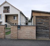 A family house on Antona Bernoláka Street in Kolárovo, with a separate wooden garage next to it.