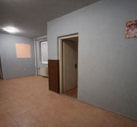 The interior of a family house with tiles, light walls, and open space.