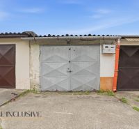 Garages on Hviezdna Street in Komárno with metal doors and a worn facade.