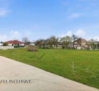 Lands - housing in Rohovce with grassy area and surrounding family houses.