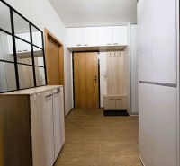 Entrance hall with storage space and wooden decor flooring in a 3-room apartment.