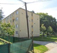 An apartment building on Lipová Street in Piešťany surrounded by greenery and trees.
