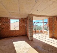 Unfinished room with open walls in a 3-room apartment without flooring with wooden decor.