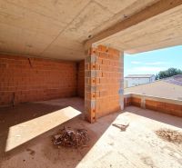 Unfinished room in a 3-room apartment with brick walls and a concrete ceiling.