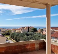 Sea view from a 3-bedroom apartment in the town of Privlaka, above the surrounding houses and trees.