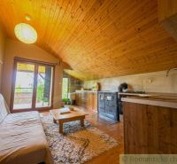 Attic space of a family house with a wooden ceiling, floor with wooden decor.