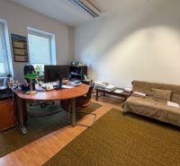Offices with carpet and wood-patterned flooring include a desk and a sofa.