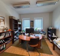 Offices with wooden floor decor, green carpet, and a large window.