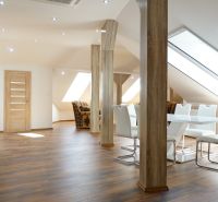 A bright interior of a 4-room apartment with a wooden decor floor and a dining table.