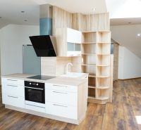 A kitchen in a 4-room apartment with built-in appliances and a wooden decor floor.