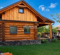 A wooden cottage in Piešťany surrounded by greenery with wood in stock.