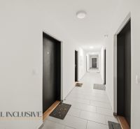 A corridor with white walls and doors in a building on Zuzany Chalupovej, Bratislava - Petržalka.