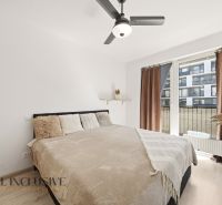 A bright bedroom with a large bed in a 2-room apartment, overlooking the terrace.