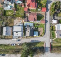 Aerial photograph of a family house in Považská Bystrica surrounded by neighboring gardens.