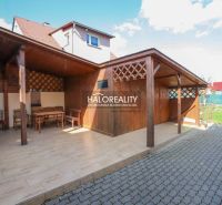 A gazebo at a family house in Považská Bystrica with a wooden decor and garden seating.