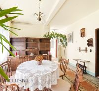 Dining room in a family house with a round table and wooden furniture.
