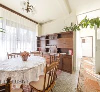 Dining room with wooden furniture and decor in a family house, bright atmosphere.