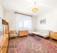 Living room of a family house with retro furniture, carpet, and wooden decor flooring.
