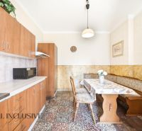 A kitchen in a family house with a dining area and cabinets with a wooden decor.