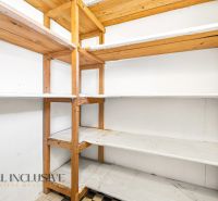 Storage space with wooden shelves in a family house.