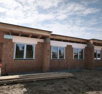 A family house on a street in Čierny Brod, in the state of rough construction with windows.