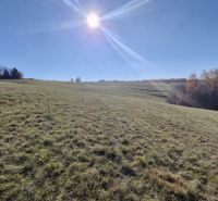 Sunny sloping plots for housing in Detvianska Huta with a view of the surrounding landscape.
