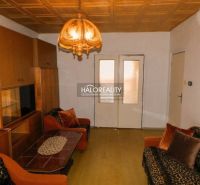 Living room in a 3-room apartment with a wooden decor floor and retro lighting.