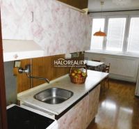 A kitchen with a built-in sink and a wooden decor floor in a 3-room apartment.