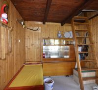 Wooden interior with a ladder, showcase, and decorations in the Garden spaces.