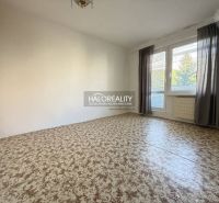 A room in a 3-room apartment with a large window and curtains, a floor with a wooden decor.