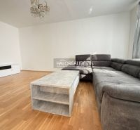 Living room in a 3-room apartment with a corner sofa and a wooden decor floor.