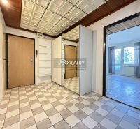 The entrance hall of a 3-room apartment with tiles and built-in cabinets.