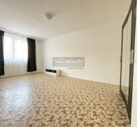 Bedroom in a 3-room apartment with carpet pattern flooring and dark curtains.