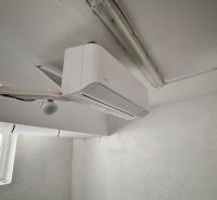 Interior of commercial premises with a window and installed air conditioning.