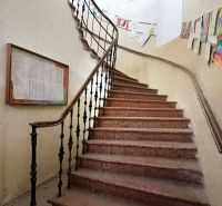 Staircase in a building of Special Properties with artworks on the walls.