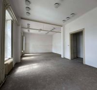 Spacious room in Special Properties with white walls and a floor with a wooden decor.