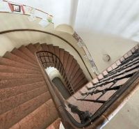 A spiral staircase with artistic decorations in Unique Properties.