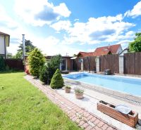 The family house on Kladnianska Street in Bratislava-Ružinov has a swimming pool, a lawn, and a fenced yard.