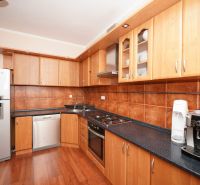 A kitchen in a family house with a wooden floor decor and cooking equipment.