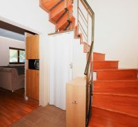 Interior of a family house with a wooden staircase and a floor with a wooden decor.
