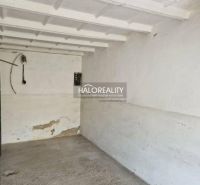 Empty garage with concrete floor and white walls.
