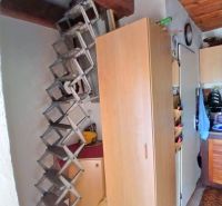 Storage spaces and stairs with wood-patterned flooring in the interior of the garden.