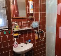 Bathroom with a mirror, sink, and shower, Gardens.