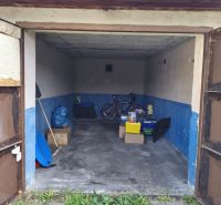 Garages on Dlha Street in Prievidza with a bicycle and various tools.