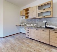 Studio apartment with a kitchenette and a wooden decor floor.